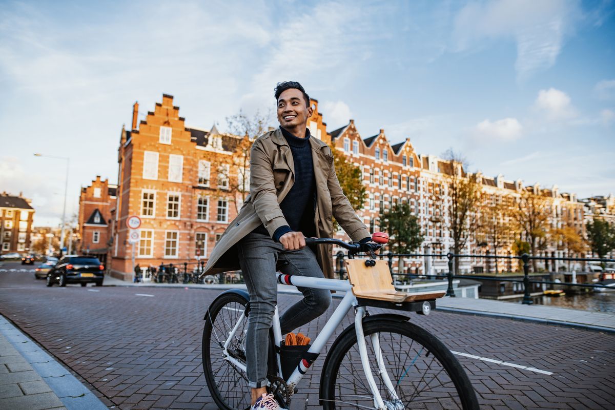 millennial asian tourist in the city with bicycle