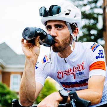 trevor raab sitting on his bike drinking from a water bottle